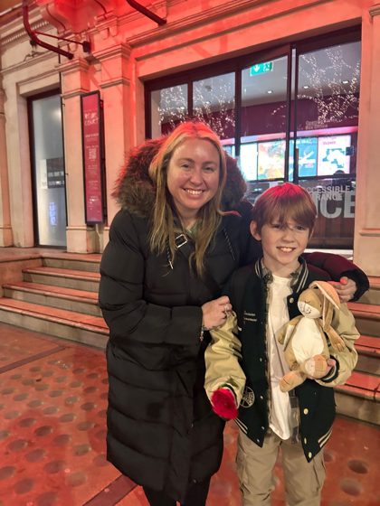 Kim with a young KTTA performer outside the Royal Court Theatre